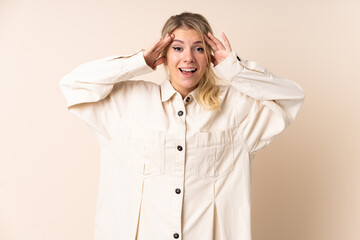 Blonde woman over isolated background with surprise expression