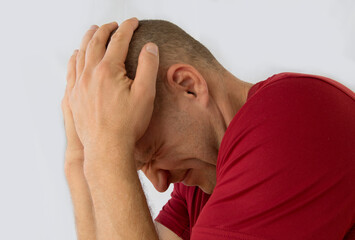 Man isolated on white background suffering from severe headache.