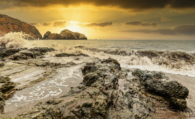Rock formations against the backdrop of the ocean in the San Francisco Recreation Area, Rodeo Beach, California, USA. Seaside, beautiful landscape, California coast.