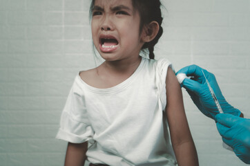 Doctor vaccinating cute little girl in hospital,Concept fight against virus covid-19 corona virus