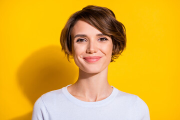 Photo of sweet charming young lady dressed white shirt smiling isolated yellow color background