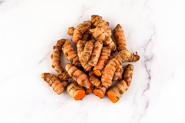 Set of various turmeric roots on a marble table. Concept of natural medicine and homeopathy
