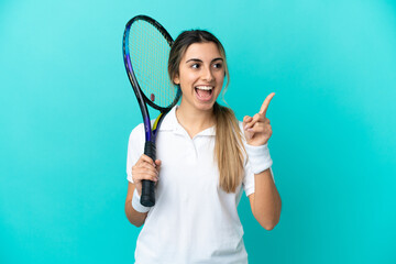 Young woman tennis player isolated on blue background intending to realizes the solution while lifting a finger up