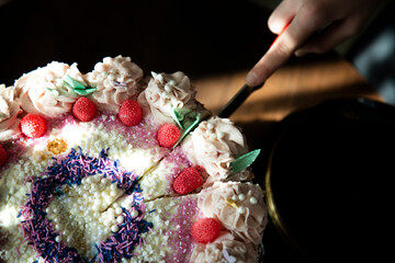 High angle view of person cutting cake