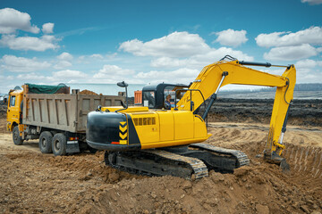 A large construction excavator of yellow color on the construction site in a quarry for quarrying....