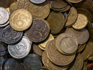 A large pile of coins from a Ukrainian bank. Concept for banking affairs, taxes, debt