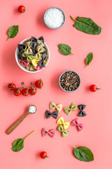 Italian colorful pasta with tomatoes and fresh basil, top view