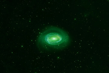 Green spiral galaxy on a dark background. Elements of this image were furnished by NASA.