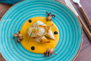 Squids with pumpkin puree and ink sauce