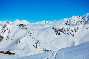 Panorama of French alps on the good sunny day, ski lift and station high in the mountain Les Arcs...