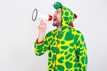 young caucasian man wearing a pajama standing against white background Through Megaphone with Available Copy Space