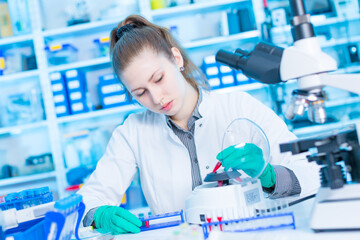 Young female laboratory assistant in laboratory analyzing environmental pollution
