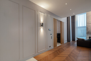 Modern wooden interior. Hardwood floor. White wall. Huge window.
