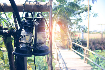 Fototapeta na wymiar Ancient lanterns hung on the wooden fence of the canal bridge