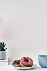 Mug and donuts cakes on a white background. Confectionery, coffee shop. Copy space, mock up.