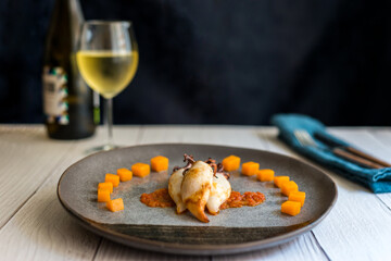 Grilled squids with diced pumpkin, crushed tomato and ink sauce