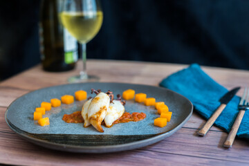 Grilled squids with diced pumpkin, crushed tomato and ink sauce