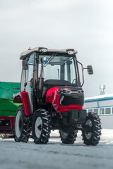 Red tractor and green trailer