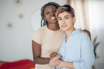 A couple standing close to each other and hugging