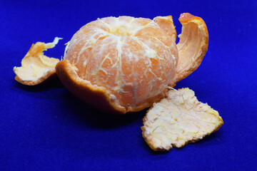 Peeled mandarin on a blue background