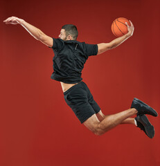 Handsome Caucasian bearded basketball player playing in basketball in sport center