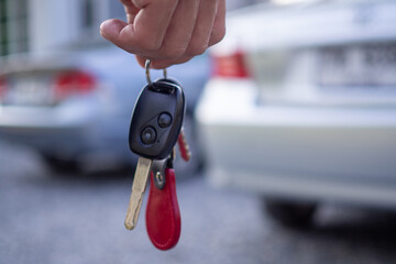 Employees sale send car keys to tourists after making a lease. Rent or buy car concept
