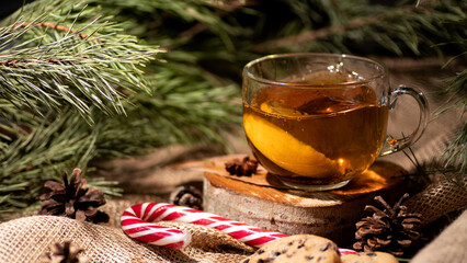 Tea with lemon, next to cookies and lollipop