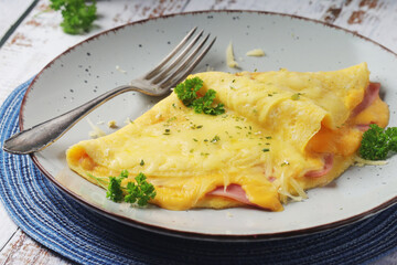 Omelette with ham and cheese on the plate