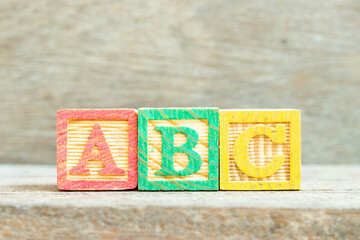 Color alphabet letter block in word abc on wood background