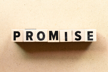 Obraz premium Alphabet etter block in word promise on wood background