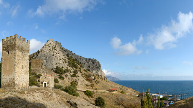 Ancient tower and church near fortress in Sudak, Crimea, Russia.