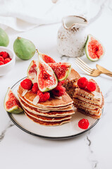 Homemade classic american pancakes with almond, fresh raspberries and figs