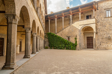 Fototapeta premium Bracciano, Rome, Italy, August 2019: Inner courtyard of the Orsini Odescalchi Castle on Bracciano Lake, built in the 15th century, Rome, Lazio, Italy