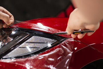 automobile detailing service. protective film on the headlight of the car.
