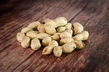 Peanuts on wooden background, composition of nuts, food background