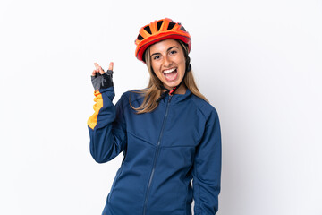 Young hispanic cyclist woman isolated on white background smiling and showing victory sign