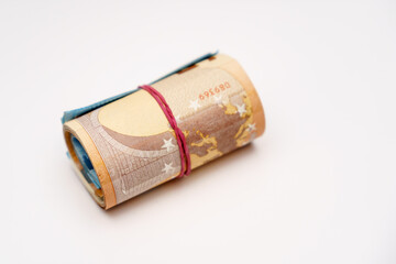 Roll of many euro money and bow isolated on white background