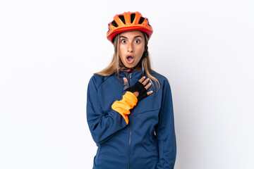 Young hispanic cyclist woman isolated on white background surprised and shocked while looking right