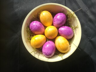 Easter decoration with colored eggs against a black background