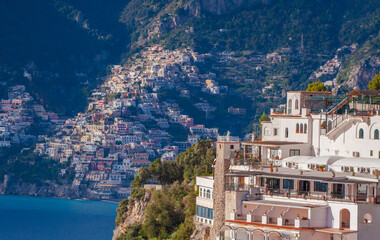 Hotel terrace and panoramic view of beautiful Amalfi on hills leading down to coast, Campania, Italy