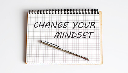 Notebook with pen , text Change Your Mindset ,concept