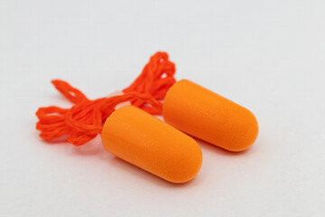 Roll-down foam earplugs on a white background