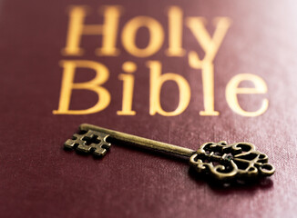 Key and bible, close up. Concept bible is key of life.