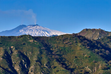 the smoking Etna Volcano a few days after an eruption, seen from the Peloritani Mountains