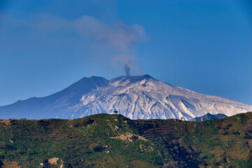 Fototapeta na wymiar the smoking Etna Volcano a few days after an eruption, seen from the Peloritani Mountains