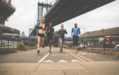 Group of urban runners running on the street in New york city, conceptual series about sport and fitness