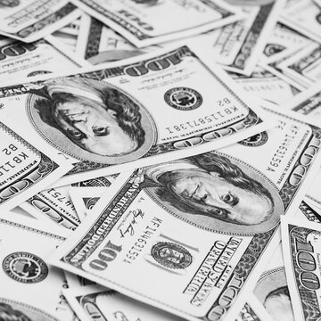 Cash hundred-dollar bills, banknotes are scattered dollar background image.