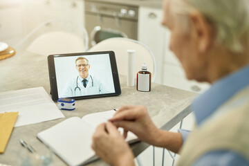 Senior man having online session with medical doctor