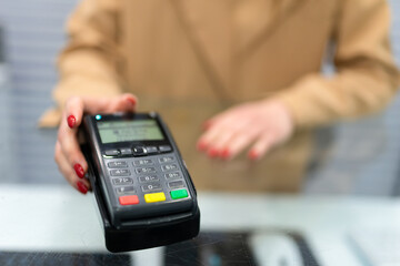 Woman gives payment terminal to client