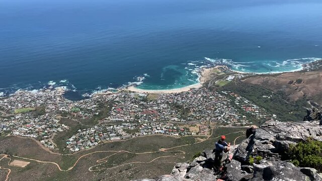 Abseiling down Table Mountain with views of Clifton , Camps Bay and Bantry Bay on the Atlantic seaboard side of the Cape Peninsula
